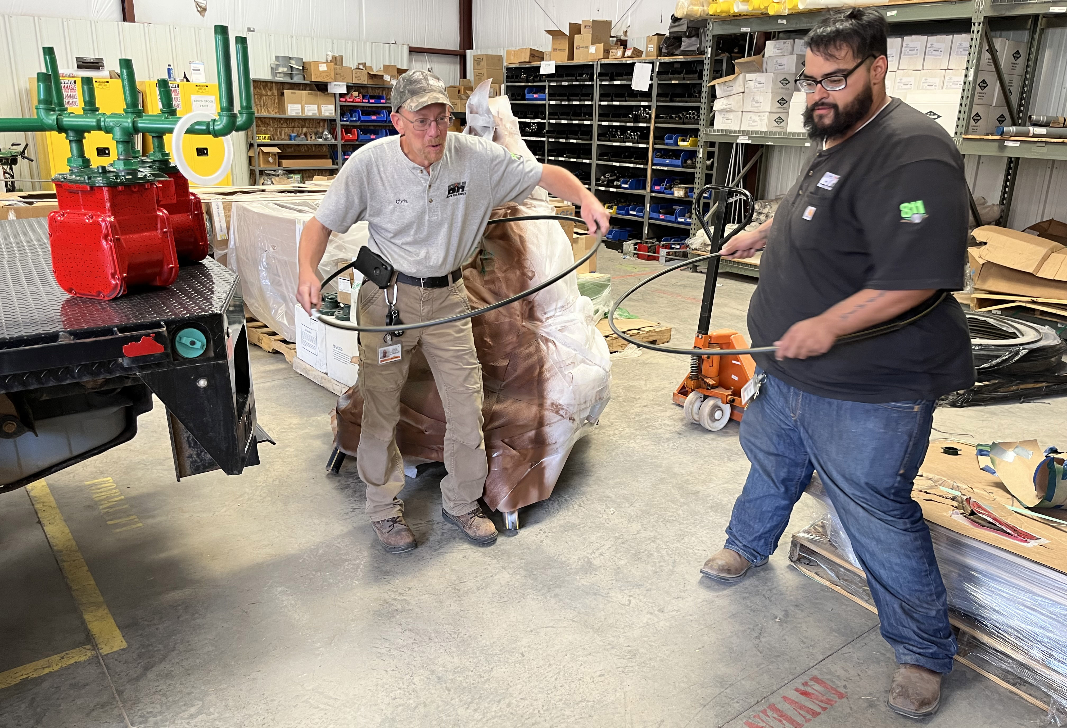 technicians making hula hoops out of pipe