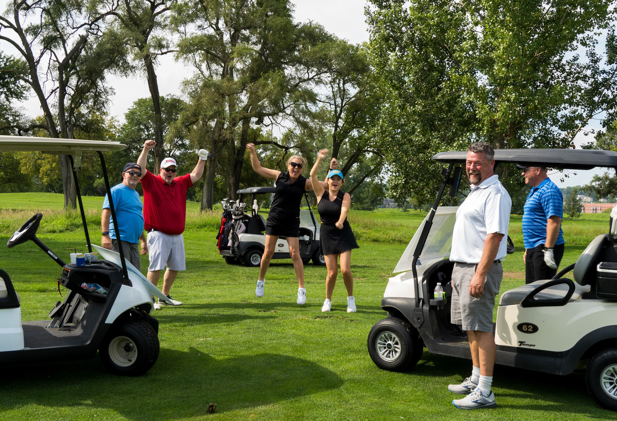 men and women golfing