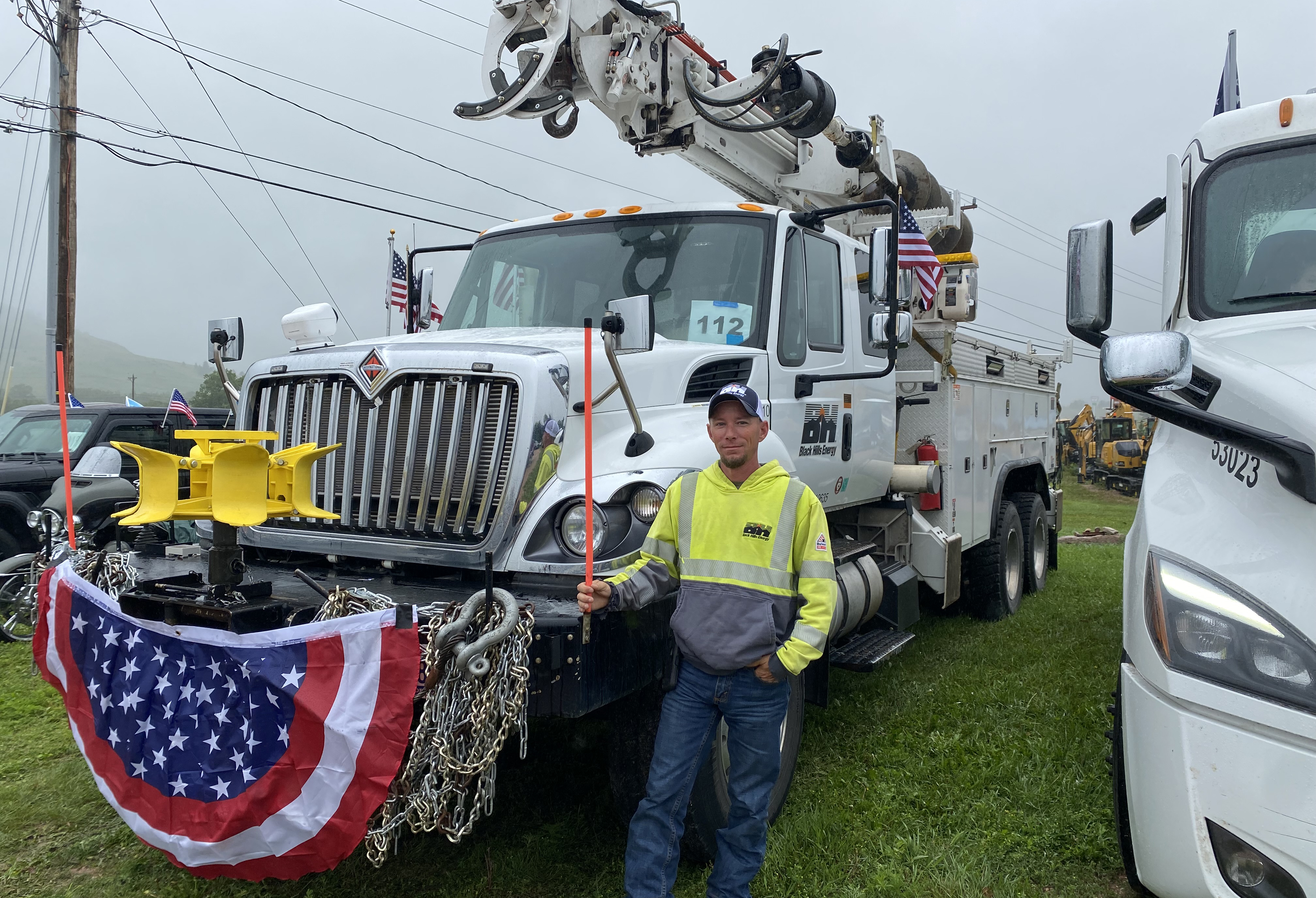 man standing in front of bucket truck